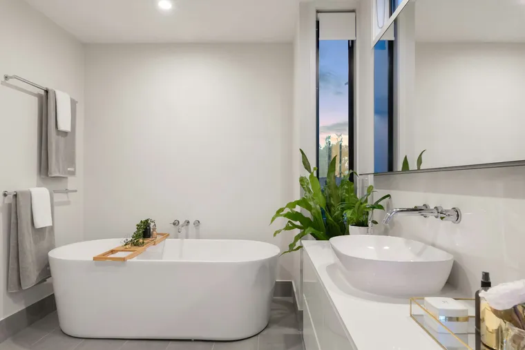 Master bathroom with tiled tub deck and freestanding tub