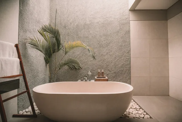 Stone-tiled bathroom with freestanding tub