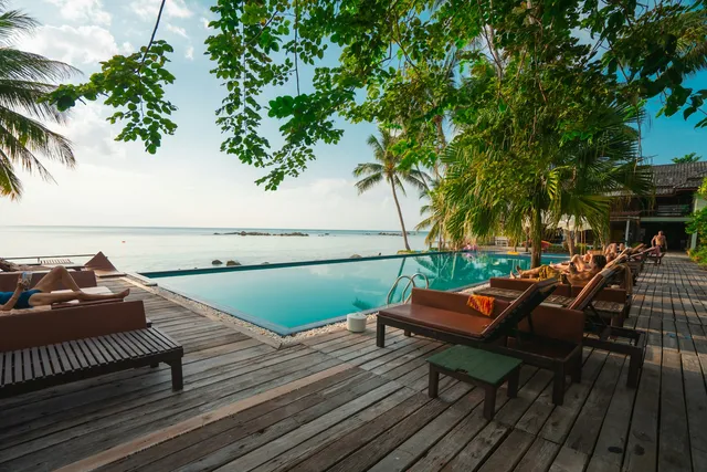 Outdoor stone patio beside a pool
